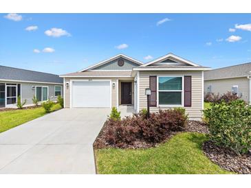 Charming single-story home with well-manicured lawn and a two car garage at 6471 Ecoff Pl, The Villages, FL 34762