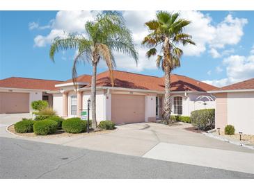 Charming home with mature landscaping and a two-car garage, perfect for comfortable living at 732 Ramirez Ave, The Villages, FL 32159