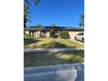 Charming single-story home with a well-manicured lawn and mature landscaping in a quiet neighborhood at 879 Little Bend Rd, Altamonte Springs, FL 32714