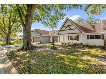 Charming single-story home featuring a brick facade, shuttered windows, and a well-manicured lawn at 8814 Sw 93Rd Ln # B, Ocala, FL 34481