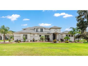 Beautiful home features a manicured lawn, well-maintained landscaping, and a modern architectural style at 1111 Myrtle Breezes Ct, Fruitland Park, FL 34731