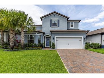 Charming two-story home with a brick driveway, lush landscaping, and inviting curb appeal at 1268 Patterson Ter, Lake Mary, FL 32746