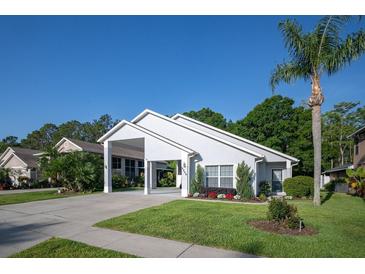 Charming single-story home with a spacious carport and well-manicured lawn with landscaped flower beds at 2539 Caithness Way, Clermont, FL 34714