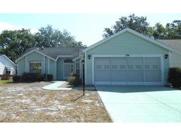 Charming single-story home featuring a two-car garage and inviting curb appeal at 739 Cortez Ave, The Villages, FL 32159