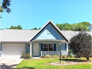 Charming single-story home showcasing a well-kept lawn and appealing front porch in a desirable community at 8431 Sw 93Rd Pl # F, Ocala, FL 34481