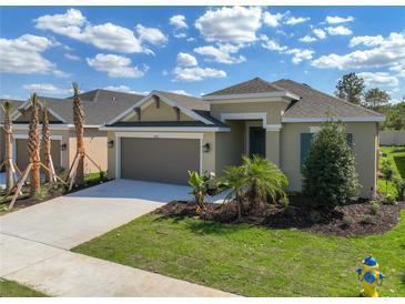 Charming single-Gathering home features a two-car garage, well-manicured lawn, and lush landscaping at 2675 Ridgetop Ln, Clermont, FL 34711