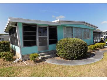 Charming single-story home featuring a screened room and well-maintained landscaping at 323 Hawthorne Blvd, Leesburg, FL 34748