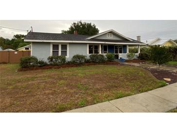 Charming single story home with light blue siding and well-manicured landscaping around the front at 604 N Old Wire Rd, Wildwood, FL 34785