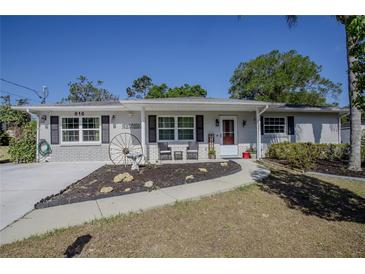 Charming single-story home with a brick accent, walkway, and a lovely landscaped front yard at 616 Third Ave, Lady Lake, FL 32159