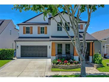 Charming two-story home with a well-manicured lawn, beautiful landscaping, and a two-car garage at 722 Barefoot Bay Loop, Groveland, FL 34736