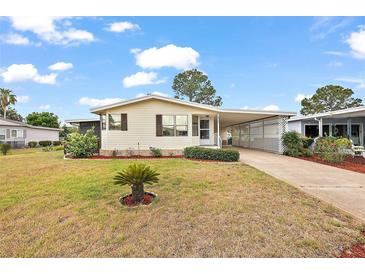 Charming single-story home featuring a covered carport and well-maintained landscaping at 2921 Wekiva Rd, Tavares, FL 32778