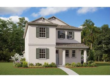 Charming two-story home featuring a landscaped yard and decorative shutters at 5129 Blanket Flower St, Apopka, FL 32712