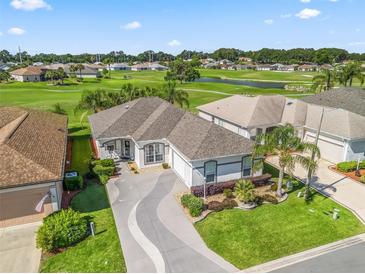 Stunning home with manicured lawn and a picturesque golf course view at 11820 Se 178Th St, Summerfield, FL 34491
