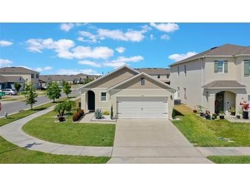 Well-maintained, single-story home featuring a two-car garage, nicely landscaped front yard, and neutral color scheme at 1548 Planters Point Rd, Kissimmee, FL 34744