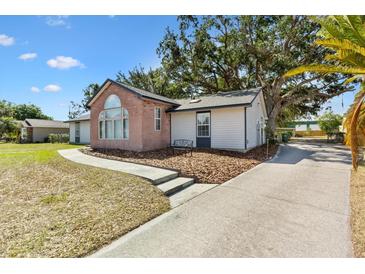Charming home featuring a brick facade with a lovely arched window and cozy bench seating out front at 307 Water Shore Dr, Leesburg, FL 34748