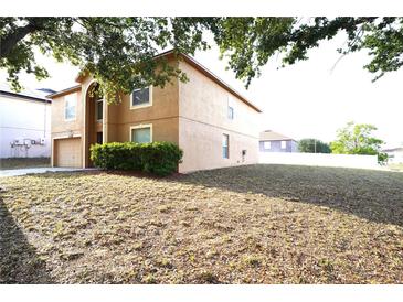 Charming two-story home with attached garage and well-maintained landscaping in a suburban neighborhood at 3329 White Blossom Ln, Clermont, FL 34711