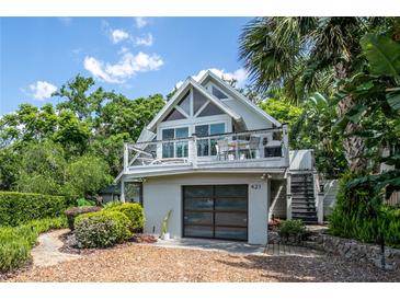 Stunning two-story home with a spacious balcony, a garage and lush landscaping at 421 W 10Th Ave, Mount Dora, FL 32757