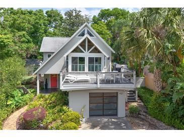 Beautiful two-story home featuring a spacious deck, modern garage, and lush landscaping at 421 W 10Th Ave, Mount Dora, FL 32757