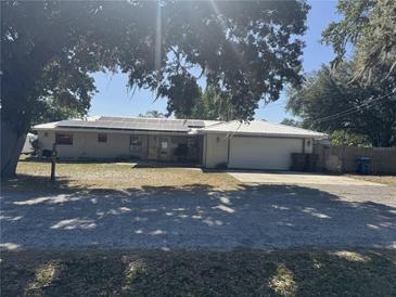 Charming single story brick home featuring a metal roof and solar panels at 916 Kentucky St, Haines City, FL 33844