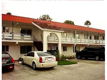 Exterior view of building with balconies, stairs, and parking lot with cars at 1100 Martinique Dr # 105, Winter Haven, FL 33884