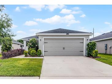 Charming single Gathering home with neutral paint, two-car garage, and manicured landscaping at 1247 Mezzavalle Way, Auburndale, FL 33823