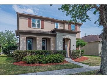 Charming two-story home featuring well-manicured landscaping and an inviting entrance at 14832 Royal Poinciana Dr, Orlando, FL 32828