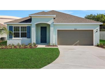 Charming single-story home with a well-manicured lawn and attached one car garage at 2860 Supermarine Rd, Tavares, FL 32778