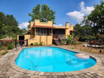 Swimming pool, yard and exterior of home showing stucco finish at 308 Sunnyside Dr, Leesburg, FL 34748