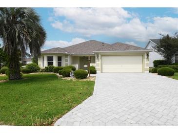 Well-maintained single-Gathering home with a paved driveway and lush landscaping at 3177 Williams Rd, The Villages, FL 32162