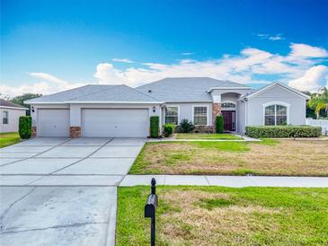 Charming single-story home with a three-car garage and well-maintained landscaping at 3731 Peaceful Valley Dr, Clermont, FL 34711