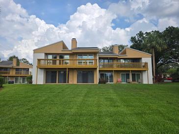 Spacious two-story condo with a large lawn and balconies on the second floor at 1051 S Highland St # D-E, Mount Dora, FL 32757