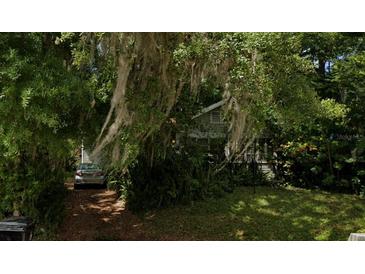 Secluded front exterior with mature trees and foliage creating a private and serene setting at 1105 Elmwood St, Orlando, FL 32801