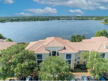 Beautiful condo complex with lake view, lush trees and well-maintained parking area at 1460 Lake Shadow Cir # 7102, Maitland, FL 32751