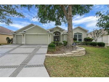 Charming single-story home featuring a well-manicured lawn and inviting curb appeal at 1828 Hollow Branch Way, The Villages, FL 32162