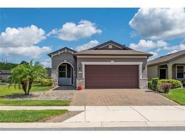 Charming single-story home with a well-manicured lawn, paver driveway, and a two-car garage at 503 Vigo St, Davenport, FL 33837