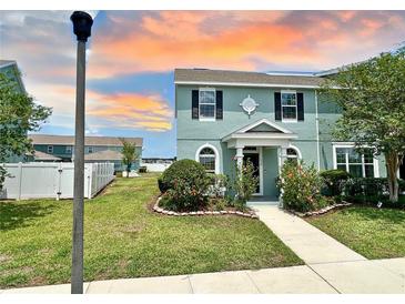 Charming two-story home with landscaped front yard and walkway leading to a covered porch at 534 Juniper Springs Dr, Groveland, FL 34736