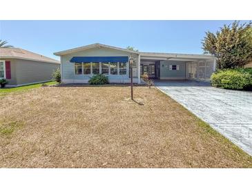 Charming single-story home with covered parking and well-maintained front yard at 608 Saint Andrews Blvd, Lady Lake, FL 32159