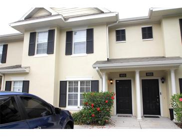 Inviting two-story townhome featuring black shutters, a well-maintained landscape, and visible unit numbers at 10115 Regent Park Dr # 2503, Orlando, FL 32825