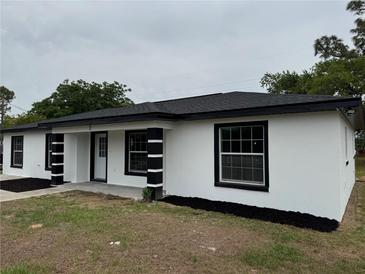 Charming single-story home featuring black and white accents, a new roof, and an easy-to-maintain landscaped yard at 2 Pine Terrace Way, Ocala, FL 34472
