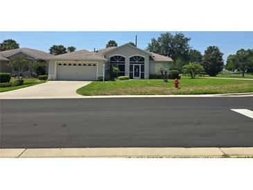 Charming single-story home with well-maintained lawn and two car garage at 5300 Treasure View Way, Leesburg, FL 34748