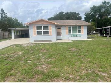 Charming single-story home with a well-maintained front yard and covered carport at 640 Mansfield Rd, Tavares, FL 32778