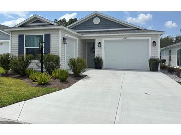 Charming single-story home with a well-manicured lawn and two-car garage, providing great curb appeal at 680 Joseph Way, The Villages, FL 34762