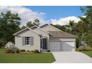 Charming single-story home with a two-car garage, landscaped yard, and a welcoming entrance at 2168 Axel St, Minneola, FL 34715