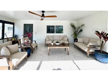 Bright living area with comfortable seating, ceiling fan, and neutral color scheme at 2227 S Spring Garden Ave, Deland, FL 32720