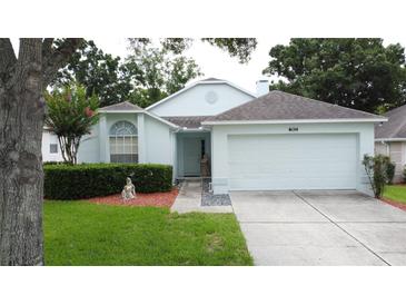 Charming single-Gathering home with a well-manicured lawn and an attached two-car garage at 3821 Doune Way, Clermont, FL 34711