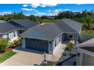 Charming single Gathering home featuring manicured front yard and a two-car garage at 4451 Elijah Loop, The Villages, FL 32163