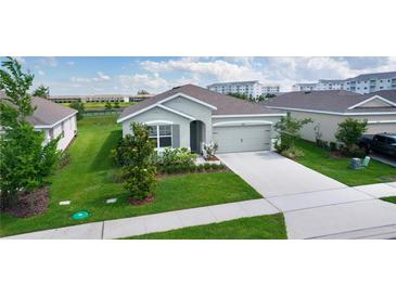 Charming single-story home showcasing a well-manicured lawn and attached two-car garage at 5043 Stokes Way, Wildwood, FL 34785