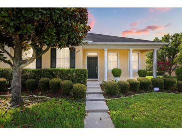 Charming home featuring a manicured front yard, lush landscaping, and a welcoming entrance at 2064 Rafton Rd, Apopka, FL 32703