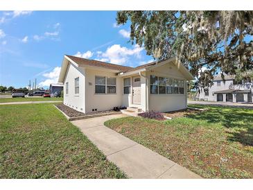 Charming single-story home with a well-maintained lawn and inviting walkway at 30 E Key Ave, Eustis, FL 32726