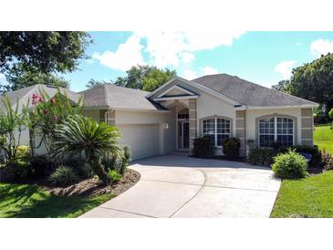 Charming single-story home with well-manicured landscaping and a paved driveway leading to an attached two-car garage at 3559 Chapel Hill Blvd, Clermont, FL 34711